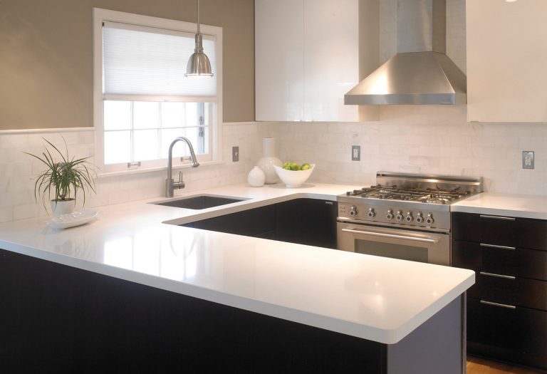 White quartz countertops with sink and black cabinets