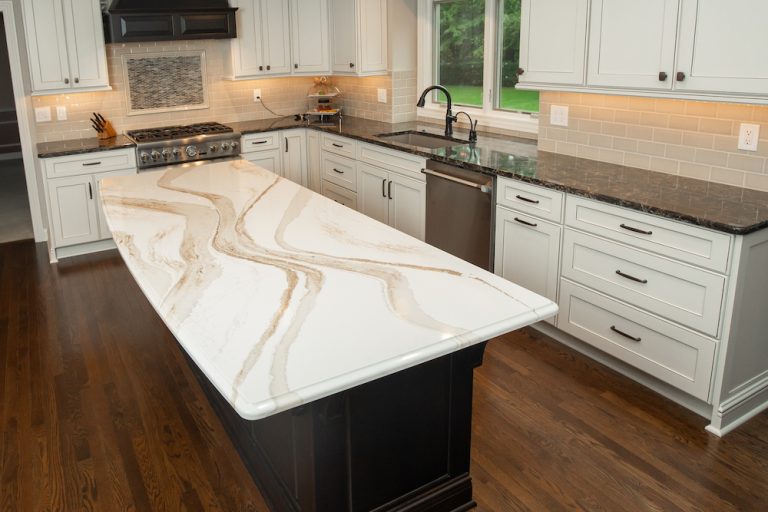 Cambria cream swirl island countertop with white cabinets