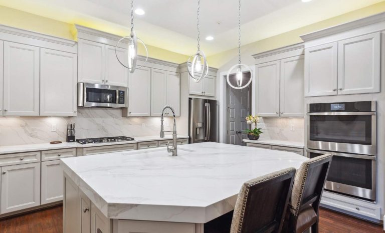 White marble kitchen island with white cabinets